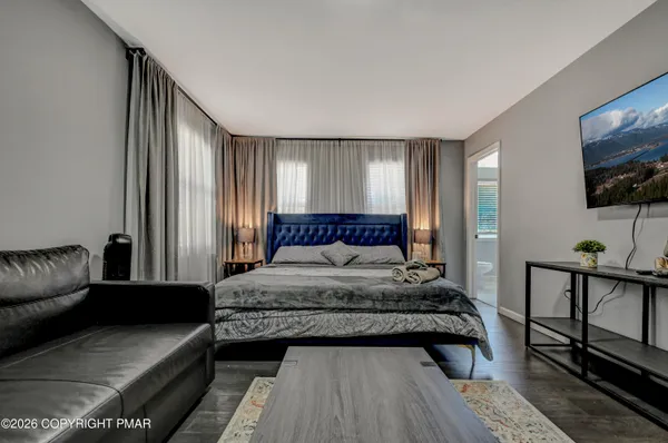 a bedroom with a bed and a flat screen tv
