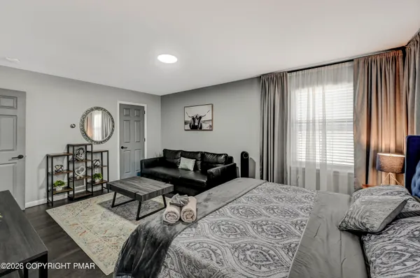 a bedroom with a bed window and a dresser in it
