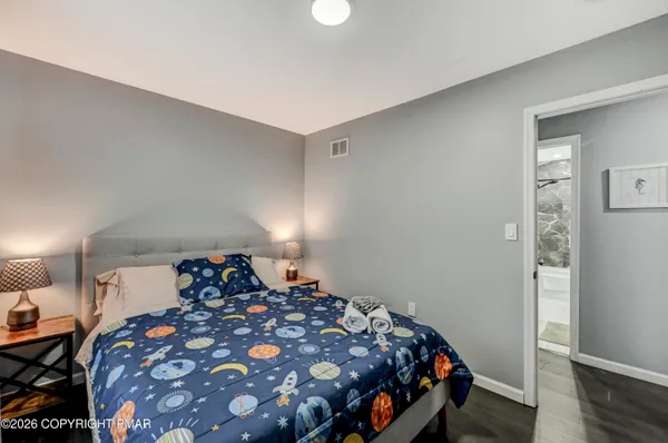 a bedroom with a bed and a lamp