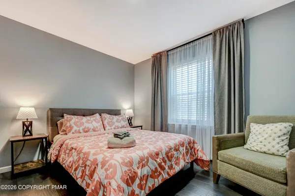 a bedroom with a bed and a couch