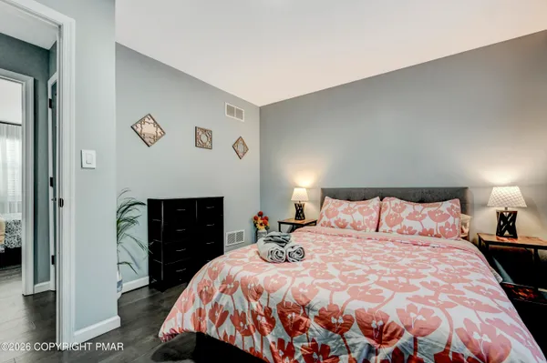 a bedroom with a bed and a lamp