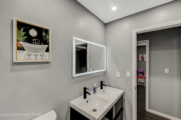 a bathroom with a sink mirror and vanity