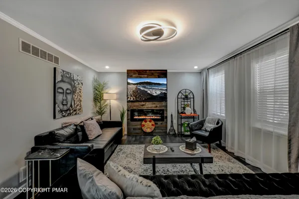 a living room with furniture a rug and a window