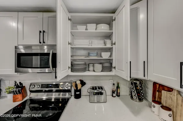 a kitchen with a refrigerator and a stove top oven