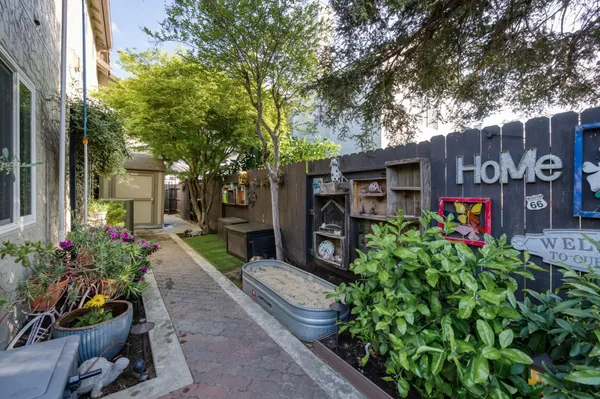 a view of house with backyard and garden