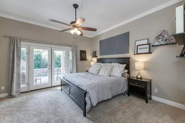a bedroom with a bed and a chandelier