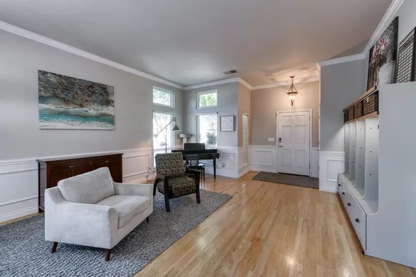 a living room with furniture and a wooden floor