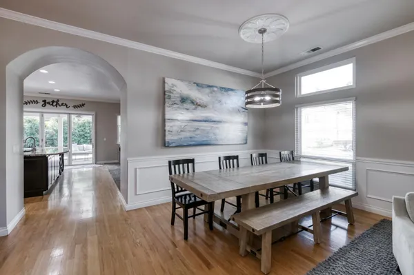 a view of a dining room with furniture wooden floor and chandelier