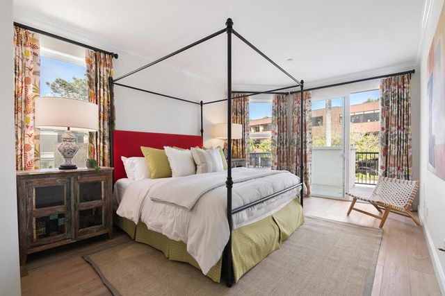 a bedroom with a bed and large window