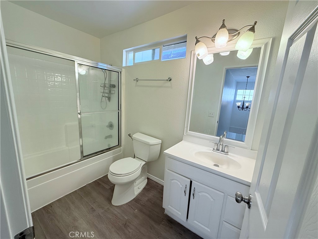 9287 Sierra Vista Circle Pico Rivera, CA 90660 - Photo 13 of 16 a bathroom with a sink a toilet a mirror and shower