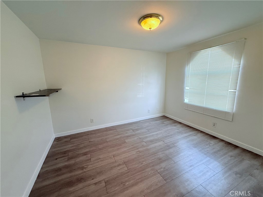 9287 Sierra Vista Circle Pico Rivera, CA 90660 - Photo 16 of 16 wooden floor in an empty room with a window
