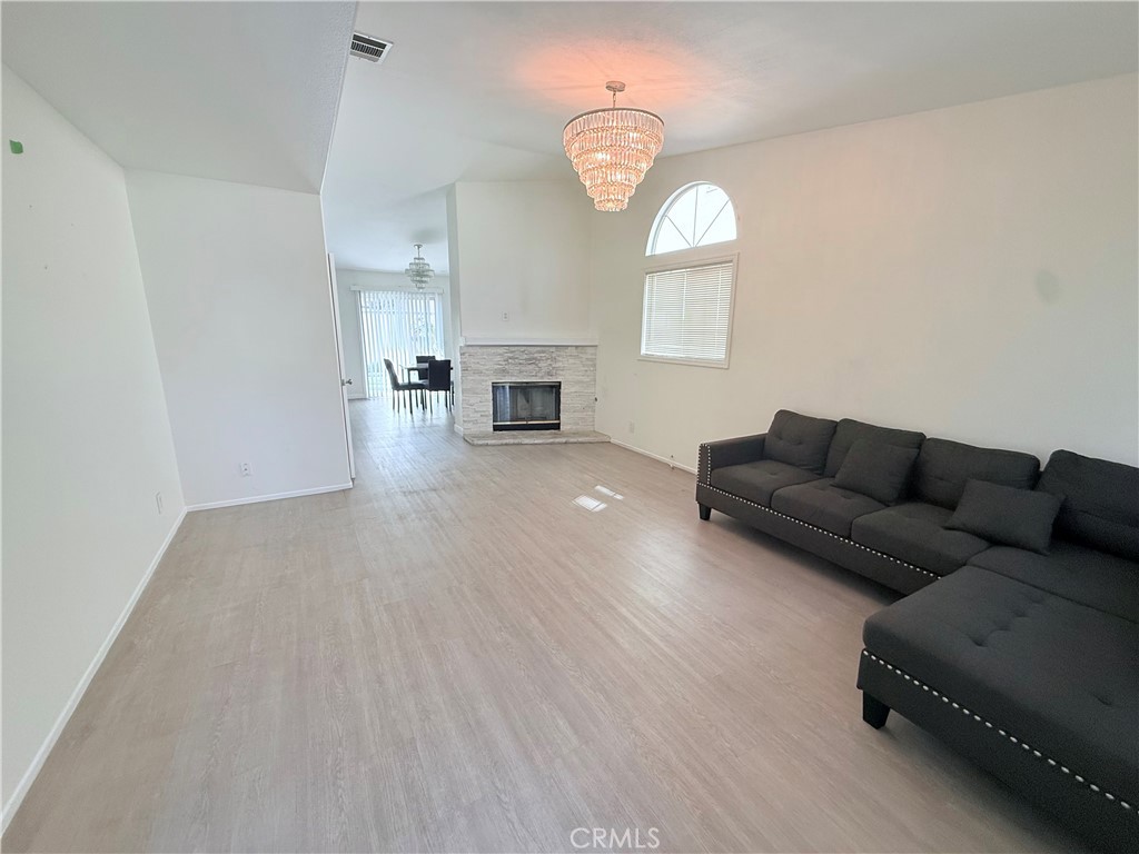 9287 Sierra Vista Circle Pico Rivera, CA 90660 - Photo 2 of 16 a living room with furniture a fireplace and a large window