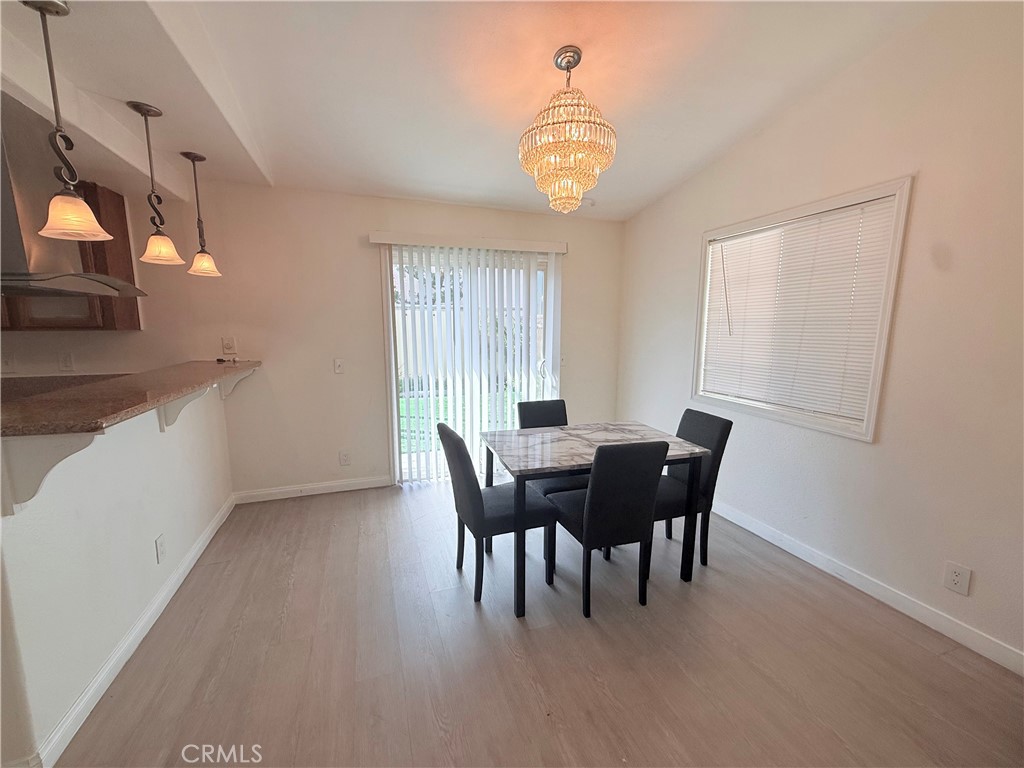 9287 Sierra Vista Circle Pico Rivera, CA 90660 - Photo 3 of 16 a view of a dining room with furniture and chandelier