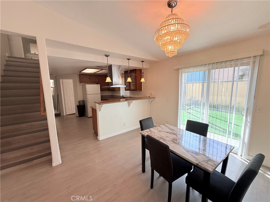 9287 Sierra Vista Circle Pico Rivera, CA 90660 - Photo 4 of 16 a view of a dining room with furniture window and wooden floor