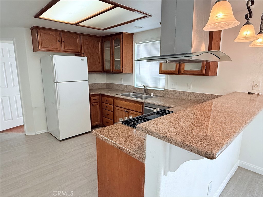 9287 Sierra Vista Circle Pico Rivera, CA 90660 - Photo 6 of 16 a kitchen with stainless steel appliances granite countertop a refrigerator a sink and a stove