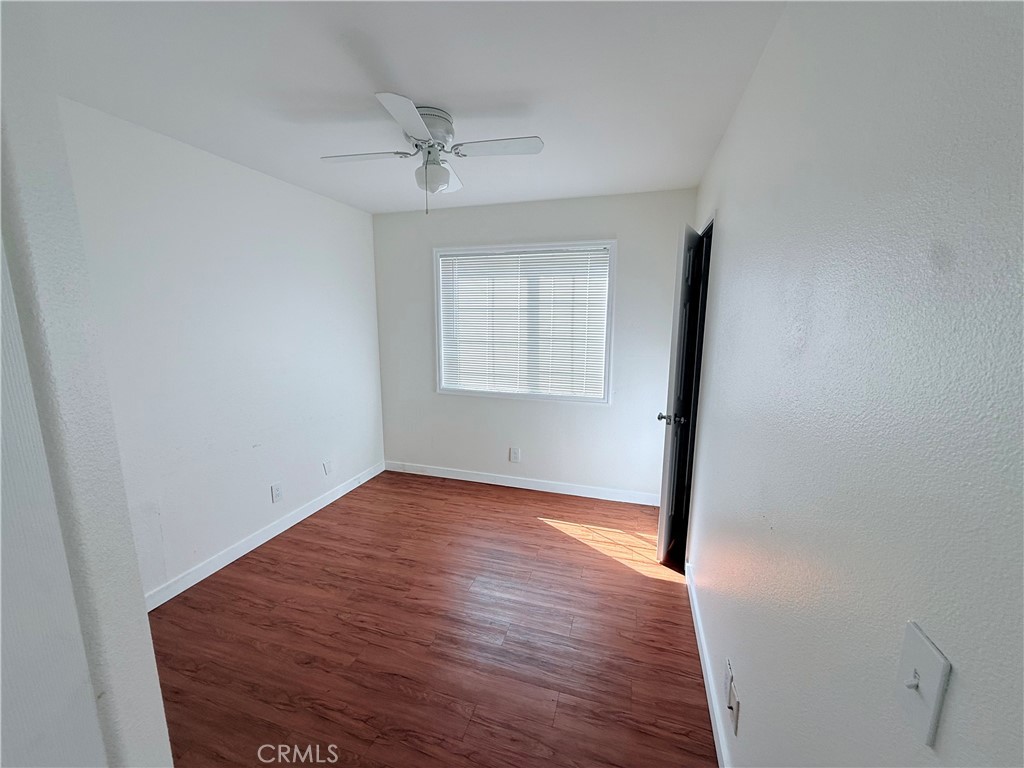 9287 Sierra Vista Circle Pico Rivera, CA 90660 - Photo 7 of 16 wooden floor in an empty room with a window