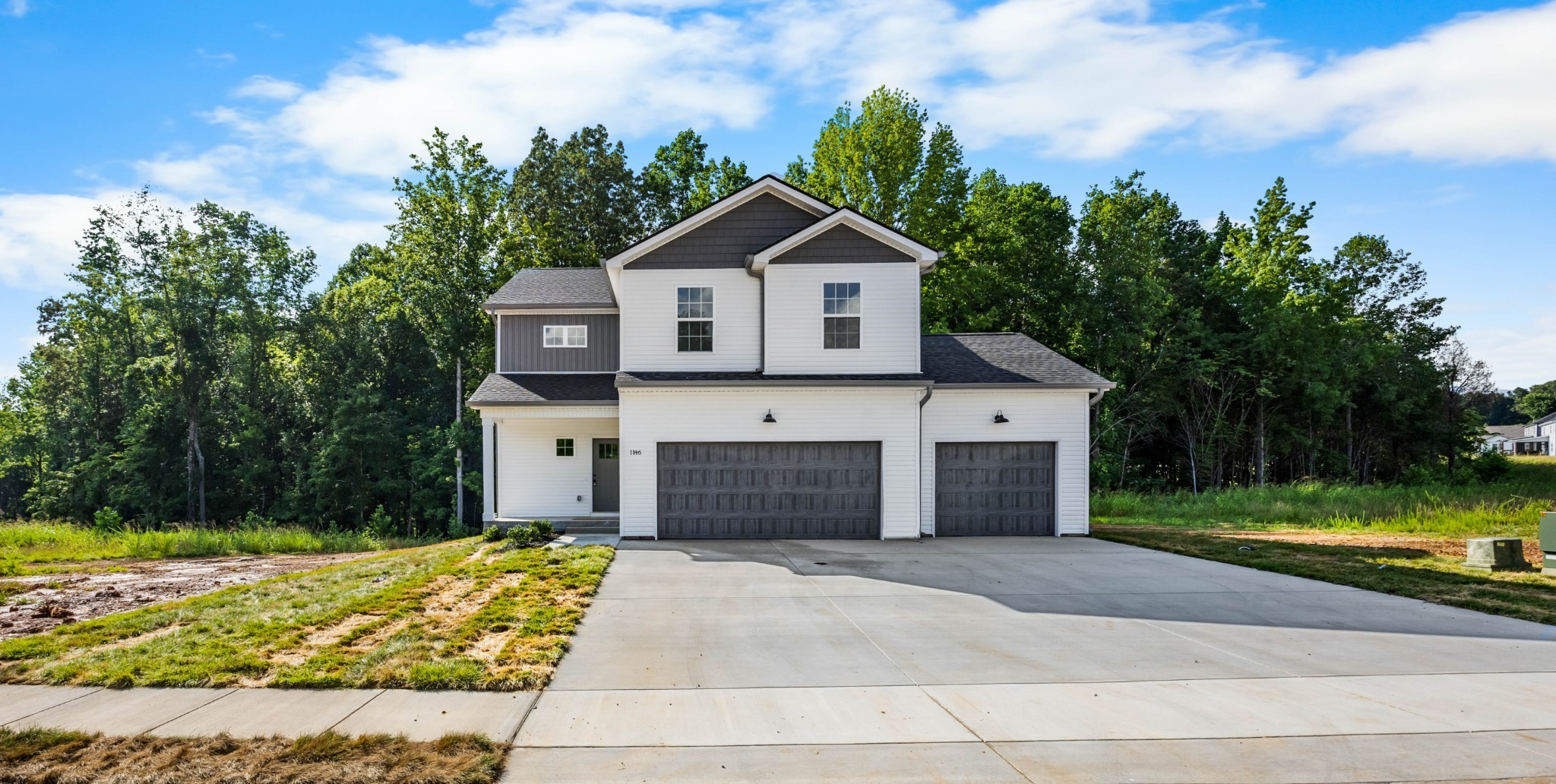 a front view of a house with a yard and garage