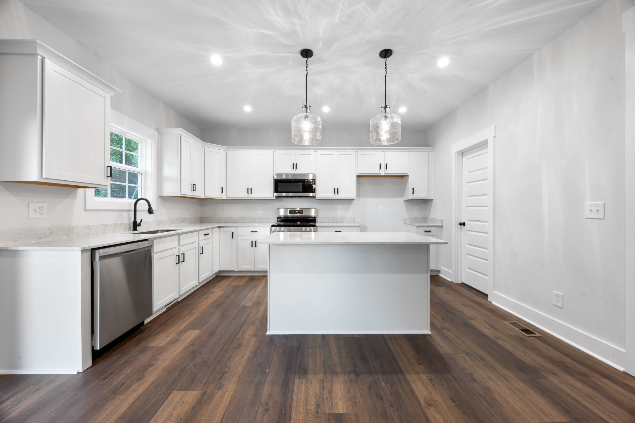 1146 Black Rock Road Clarksville, TN 37040 - Photo 12 of 36 a large kitchen with cabinets wooden floor and stainless steel appliances