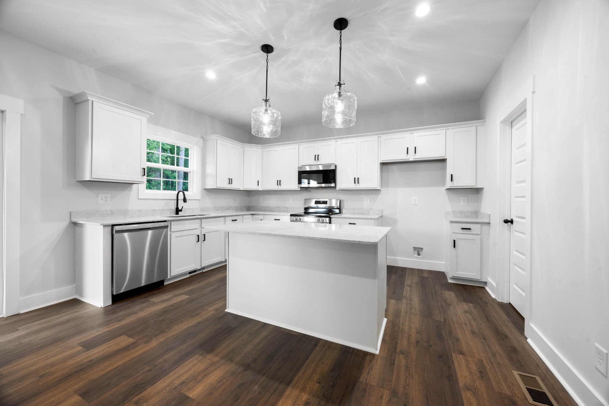 1146 Black Rock Road Clarksville, TN 37040 - Photo 13 of 36 a kitchen with stainless steel appliances kitchen island hardwood floor sink and stove