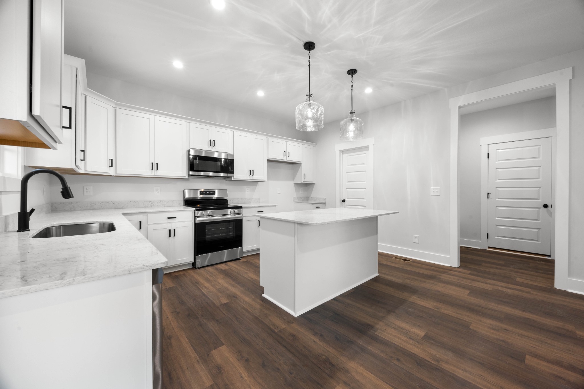 1146 Black Rock Road Clarksville, TN 37040 - Photo 14 of 36 a kitchen with stainless steel appliances kitchen island granite countertop a stove a sink and a refrigerator