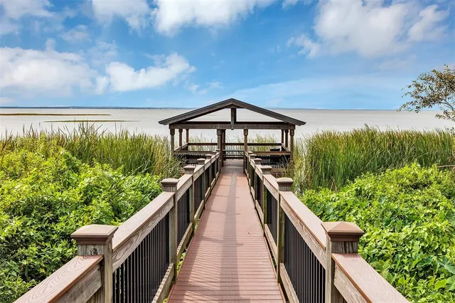an aerial view of residential houses with outdoor space and parking