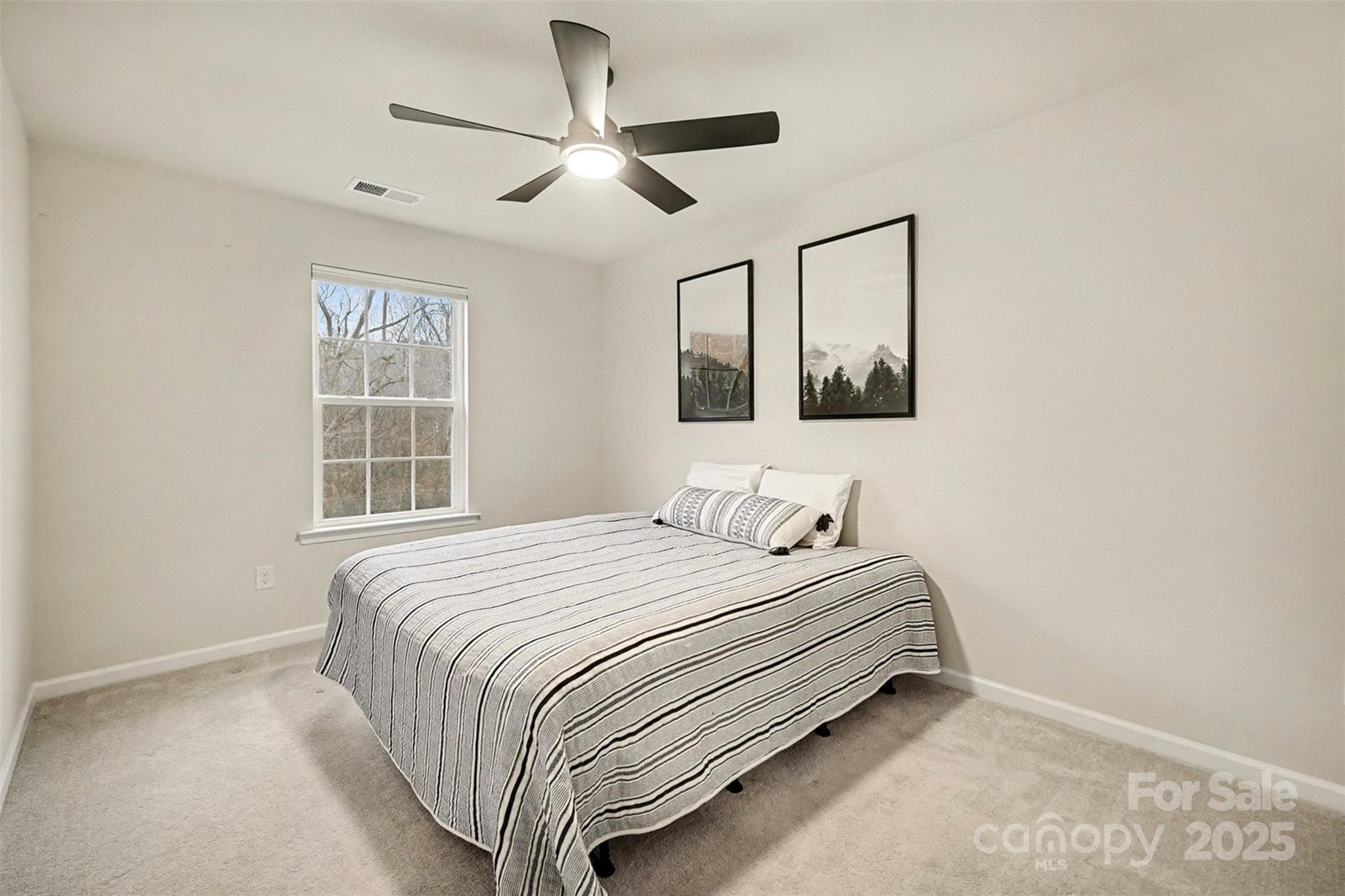 152 Tackle Troutman, NC 28166 - Photo 19 of 31 a bedroom with a bed and a window