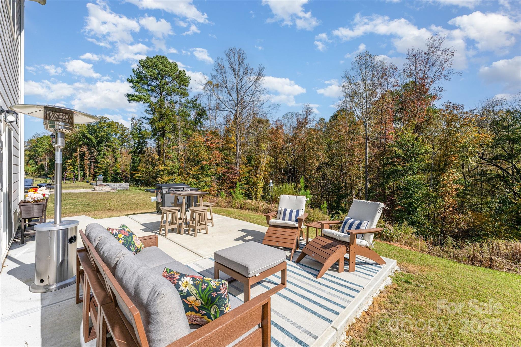 152 Tackle Troutman, NC 28166 - Photo 26 of 31 a view of a patio with table and chairs and floor to ceiling window