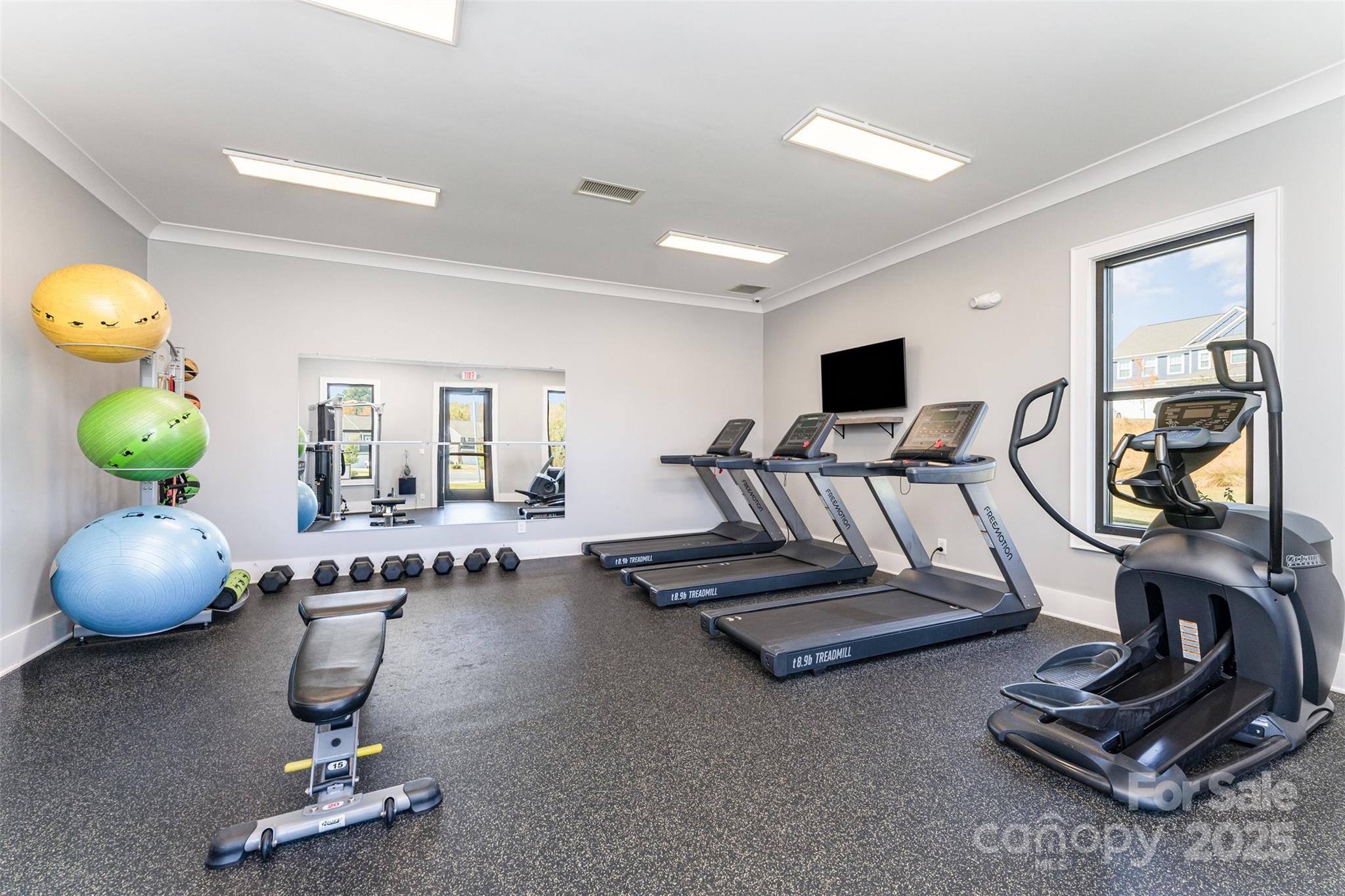 152 Tackle Troutman, NC 28166 - Photo 28 of 31 a room with gym equipment and a view of living room