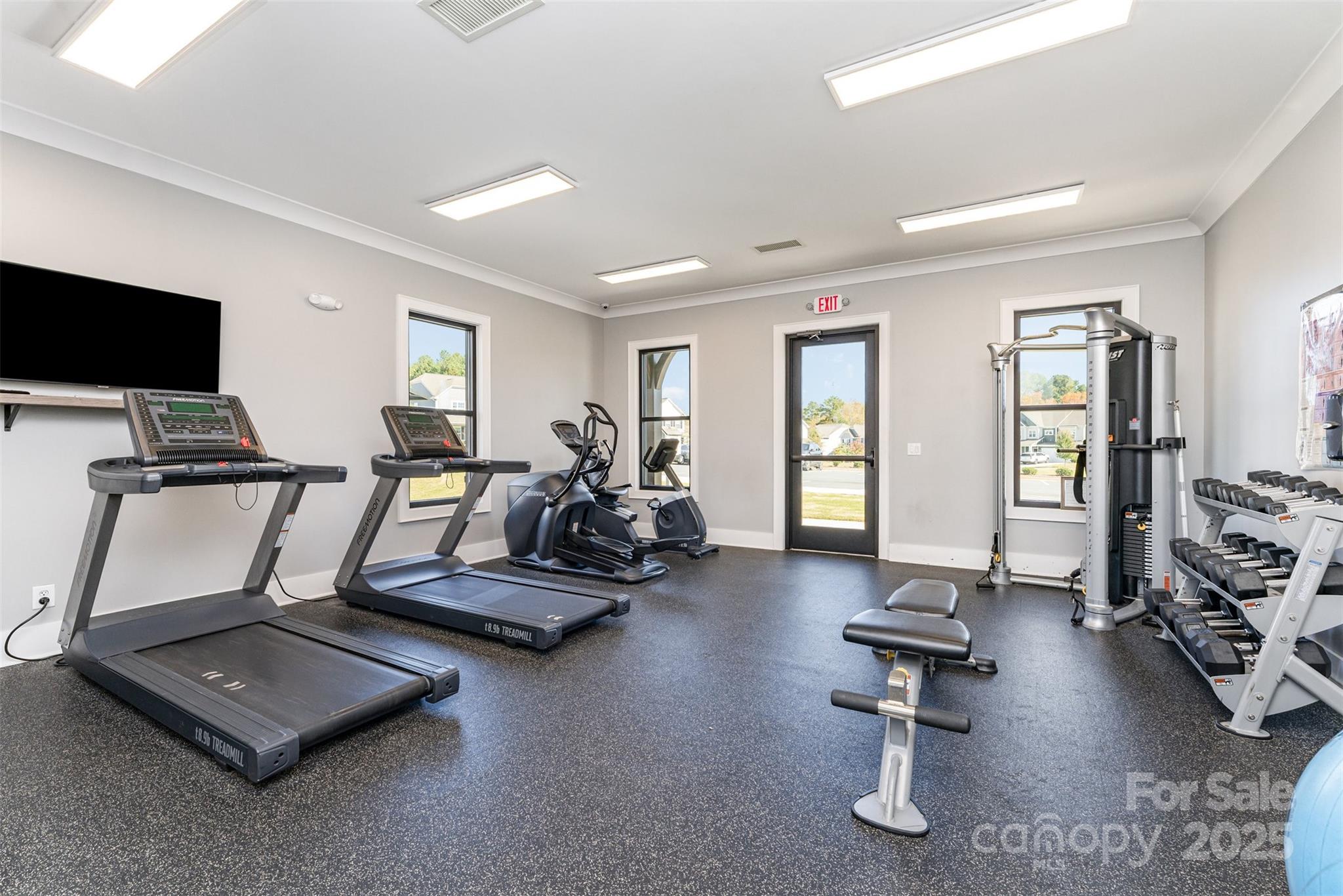 152 Tackle Troutman, NC 28166 - Photo 29 of 31 a room with gym equipment and a large window