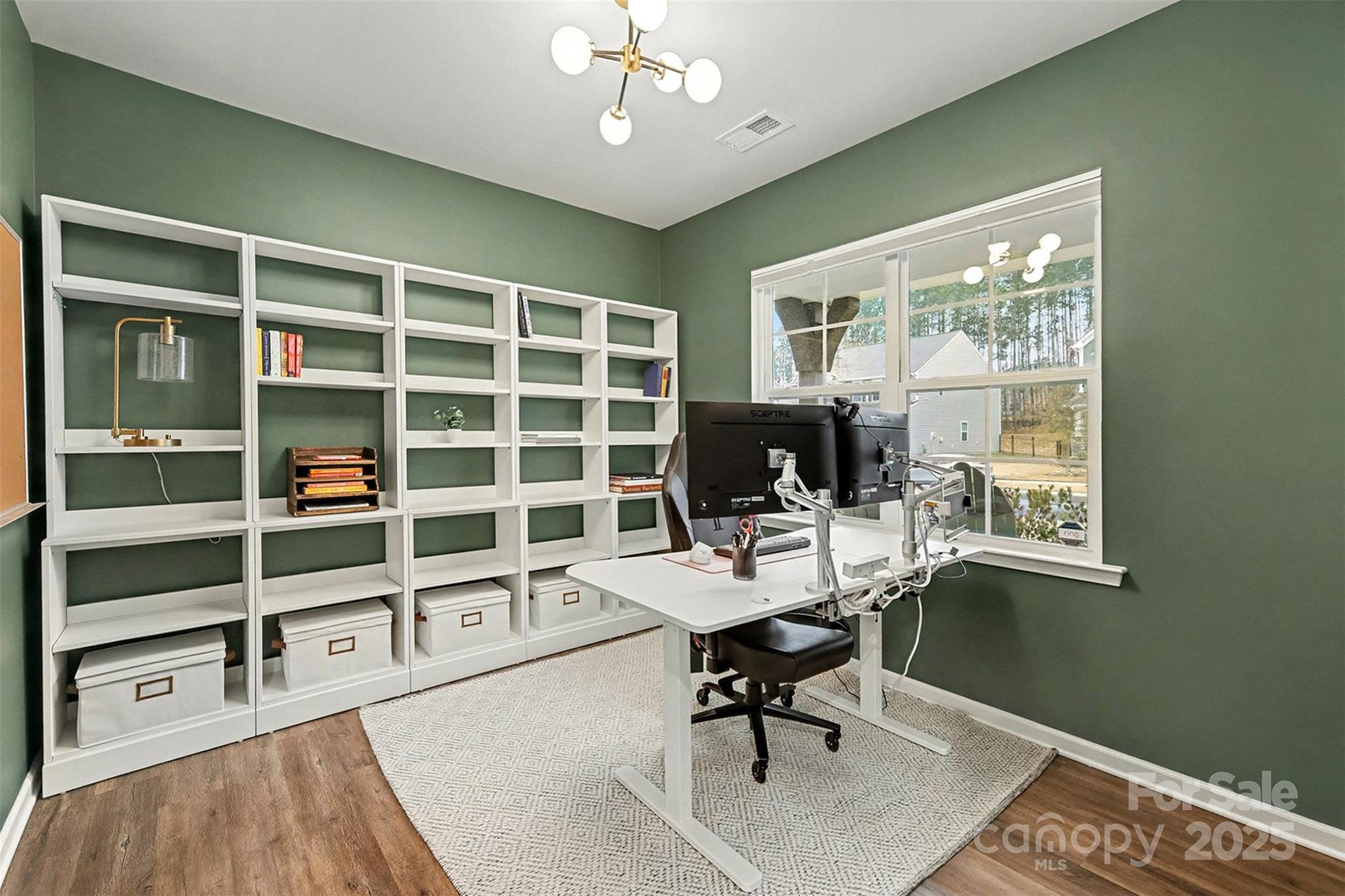 152 Tackle Troutman, NC 28166 - Photo 7 of 31 a workspace with wooden floor and a window