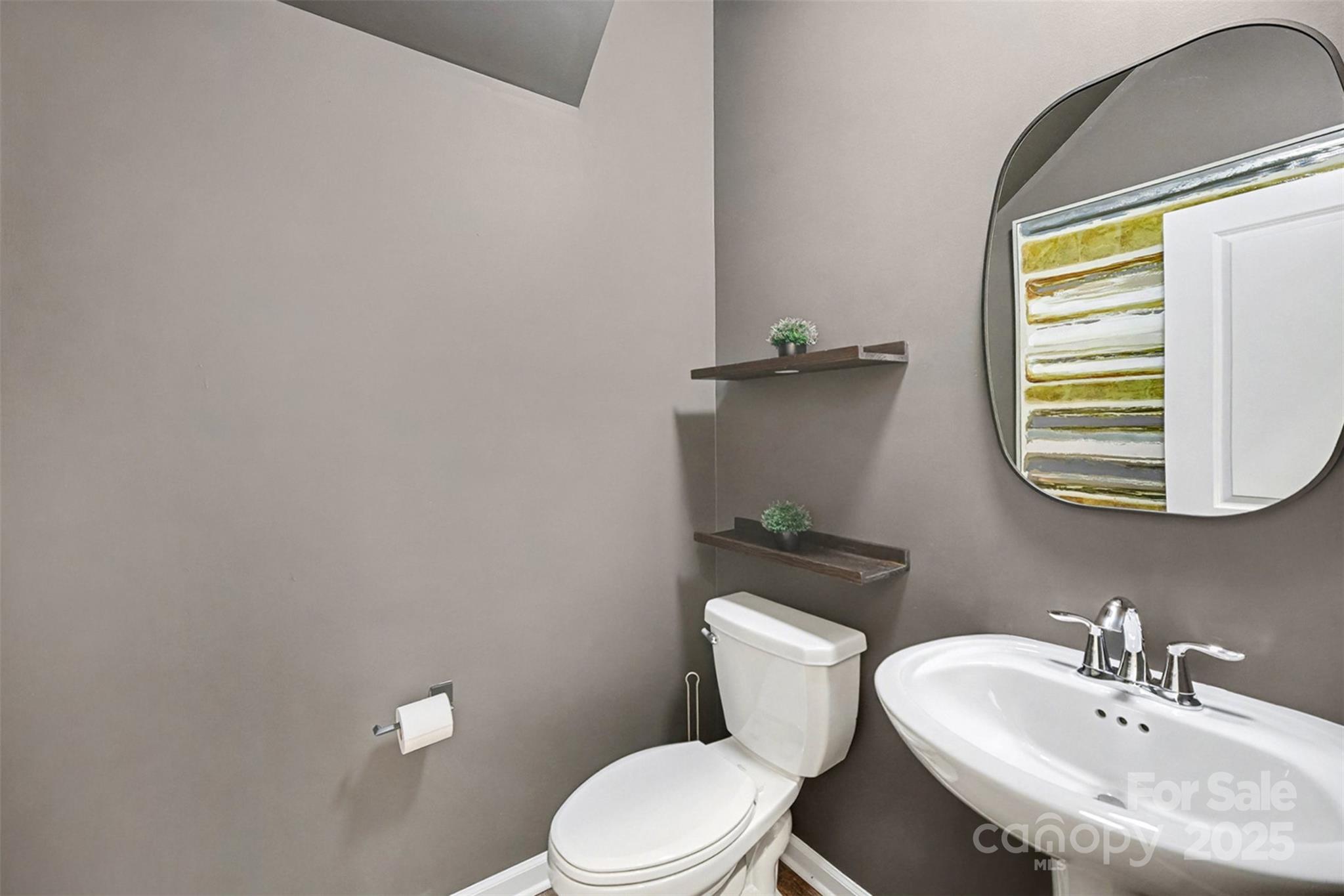 152 Tackle Troutman, NC 28166 - Photo 10 of 31 a bathroom with a sink a mirror and a toilet