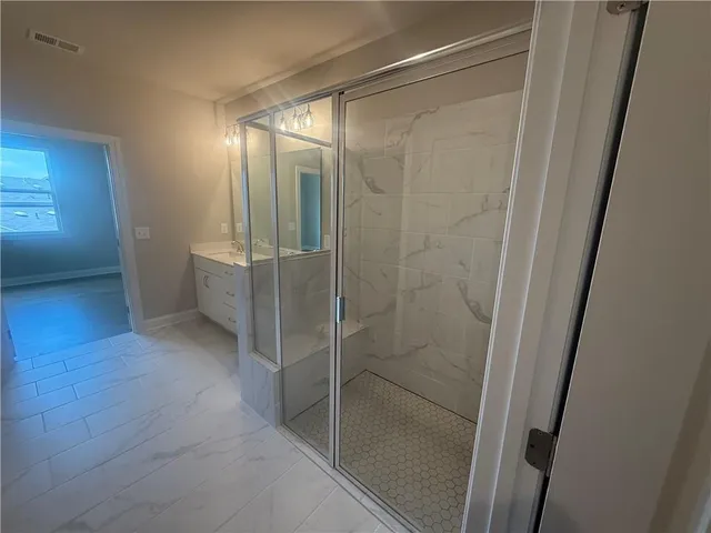 a bathroom with a glass shower door