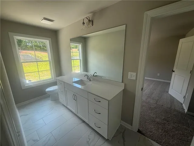 a spacious bathroom with 2 sink tub and a mirror