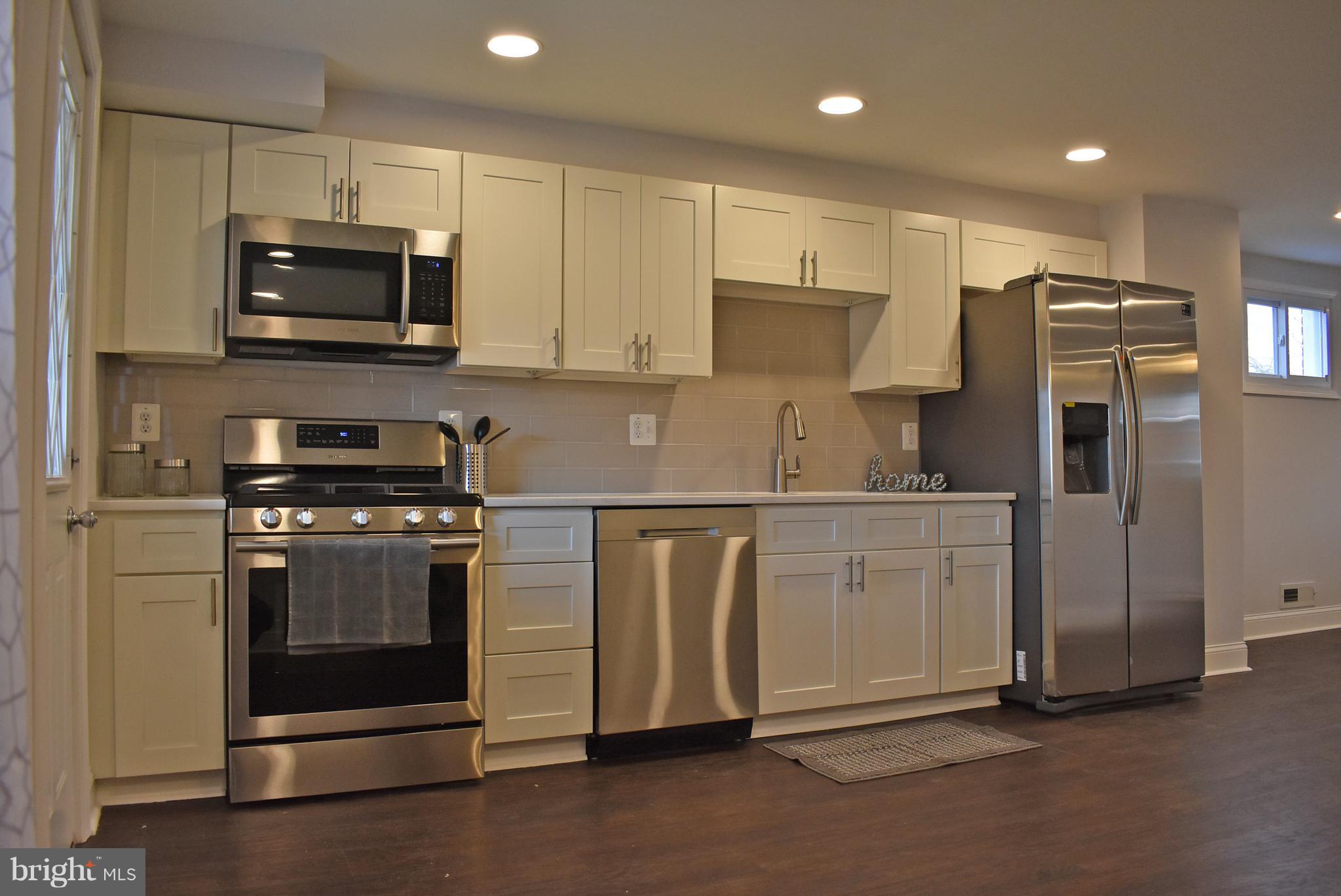 7809 Harold Road Baltimore, MD 21222 - Photo 12 of 36 a kitchen with stainless steel appliances a refrigerator stove and microwave