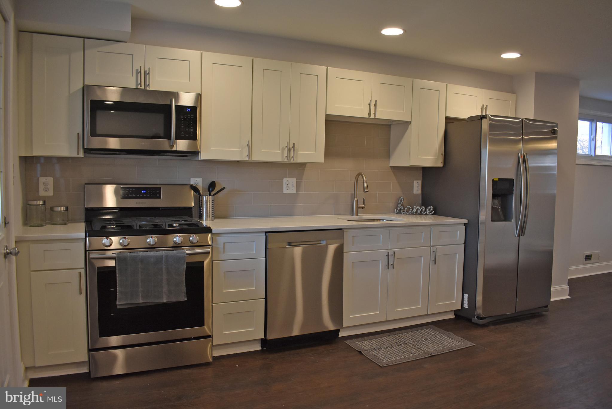 7809 Harold Road Baltimore, MD 21222 - Photo 13 of 36 a kitchen with stainless steel appliances granite countertop a refrigerator stove a sink and a microwave