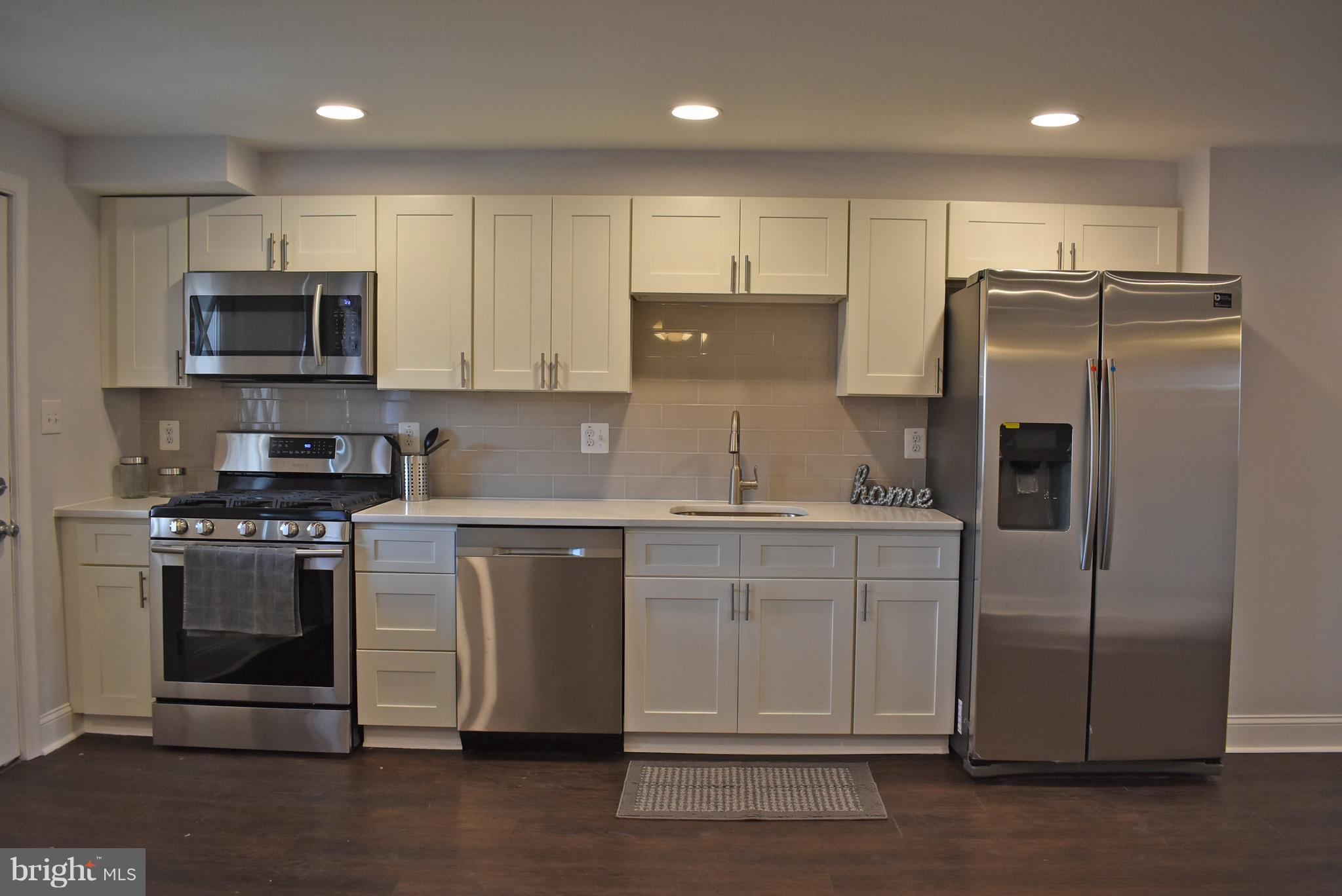 7809 Harold Road Baltimore, MD 21222 - Photo 14 of 36 a kitchen with stainless steel appliances granite countertop a refrigerator a stove a sink and a microwave