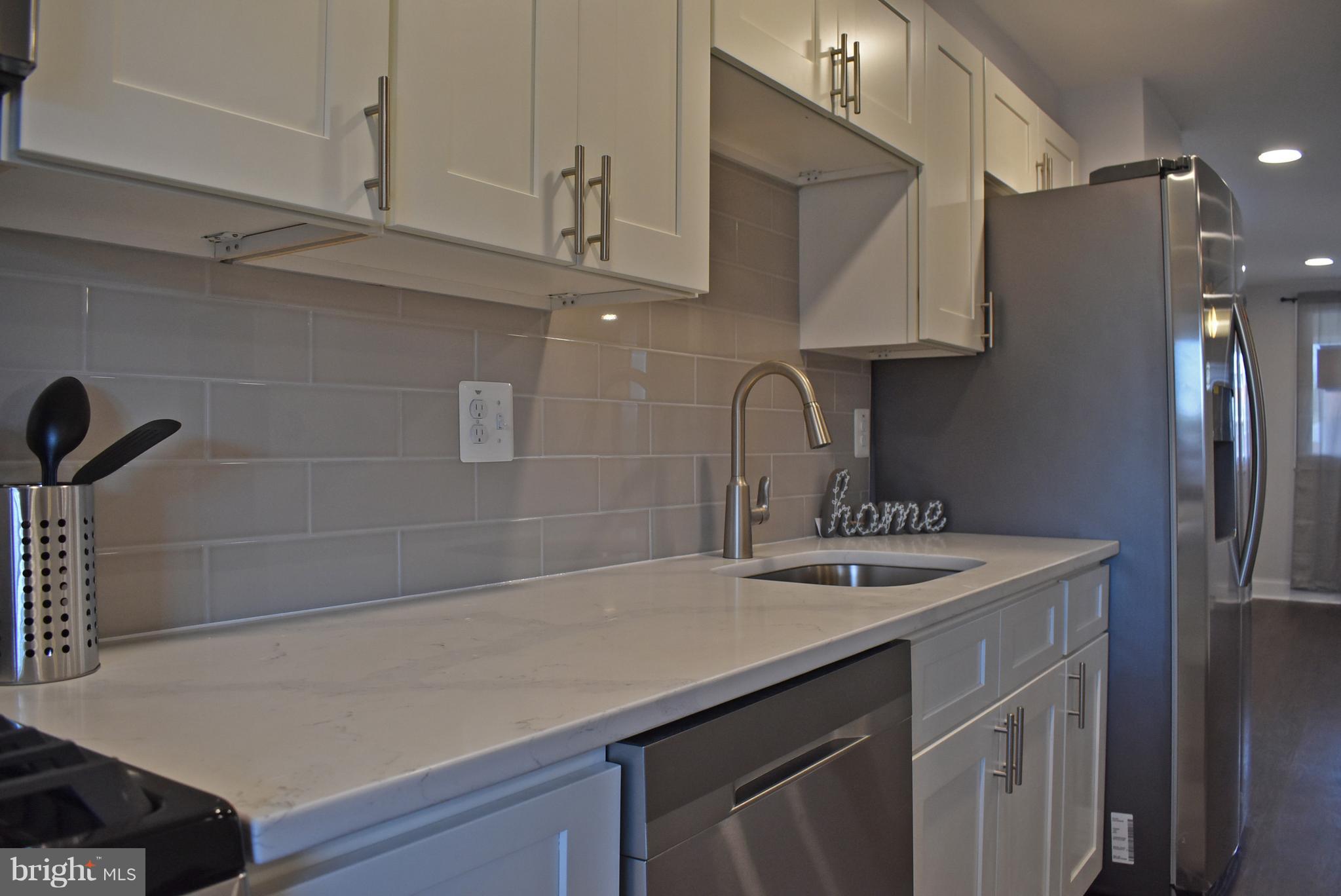 7809 Harold Road Baltimore, MD 21222 - Photo 15 of 36 a kitchen with a sink cabinets and stainless steel appliances