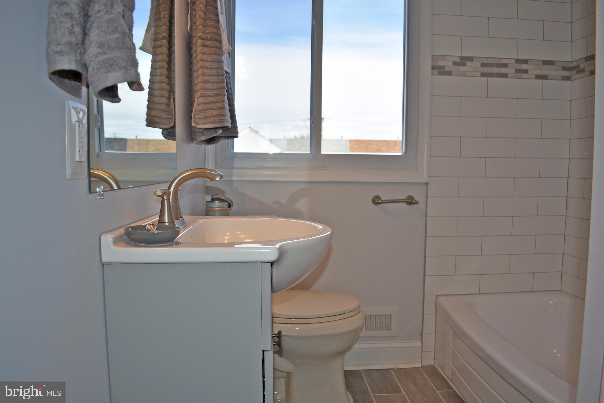 7809 Harold Road Baltimore, MD 21222 - Photo 29 of 36 a bathroom with a sink toilet and shower