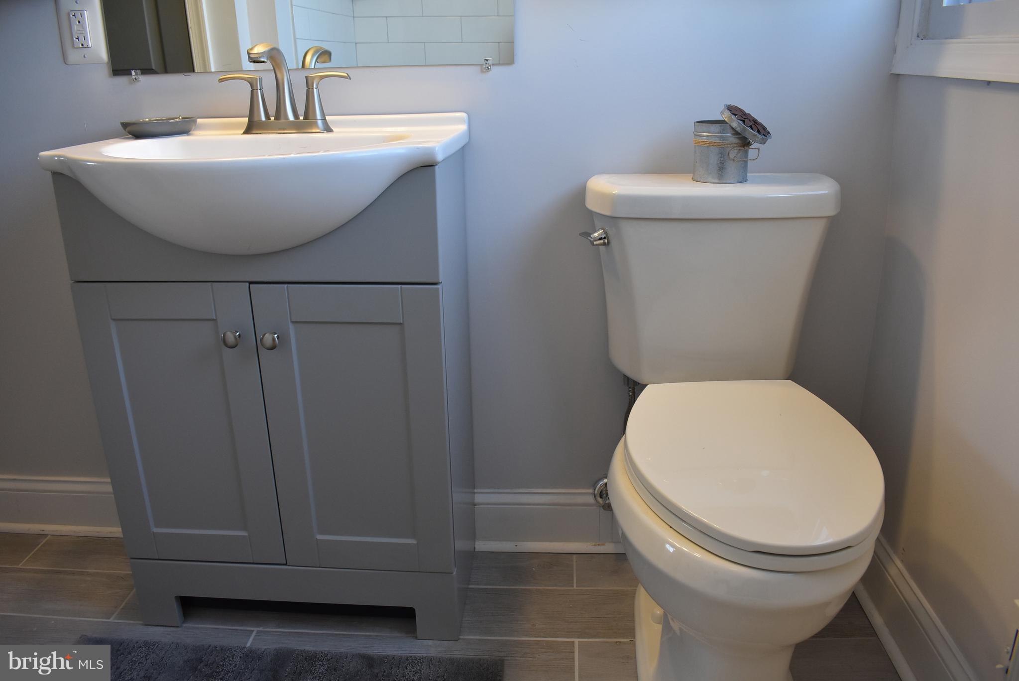 7809 Harold Road Baltimore, MD 21222 - Photo 31 of 36 a bathroom with a sink toilet and a mirror