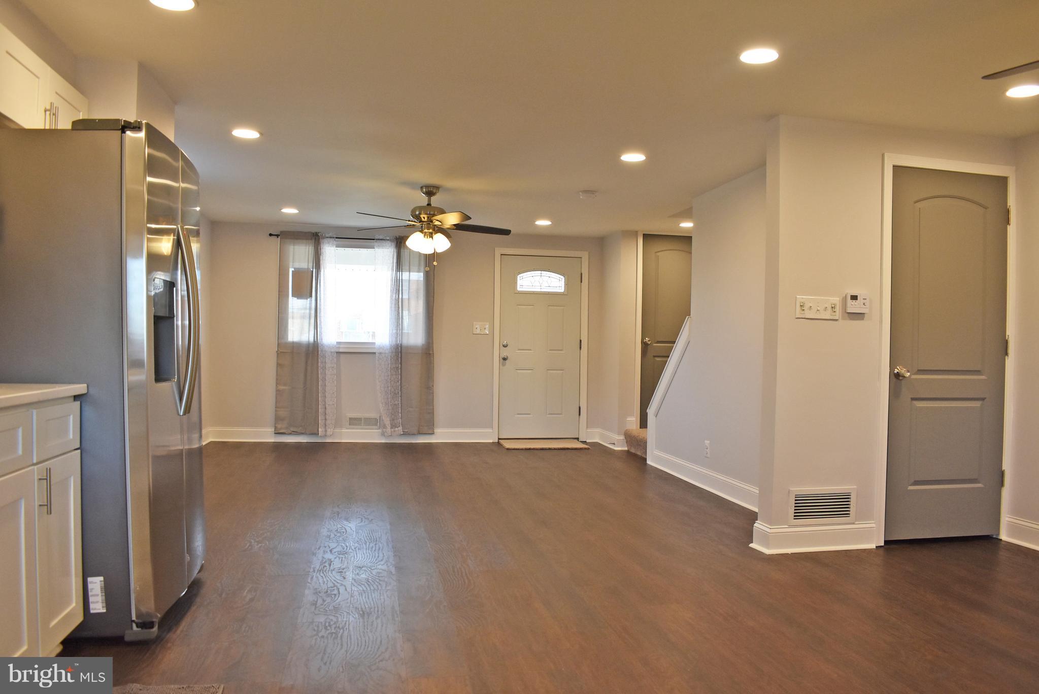 7809 Harold Road Baltimore, MD 21222 - Photo 10 of 36 a view of an empty room with wooden floor and a ceiling fan