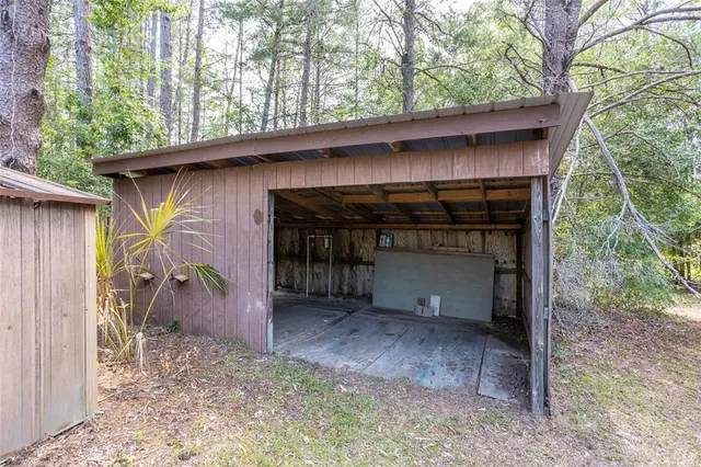 a view of an empty room with a window and closet