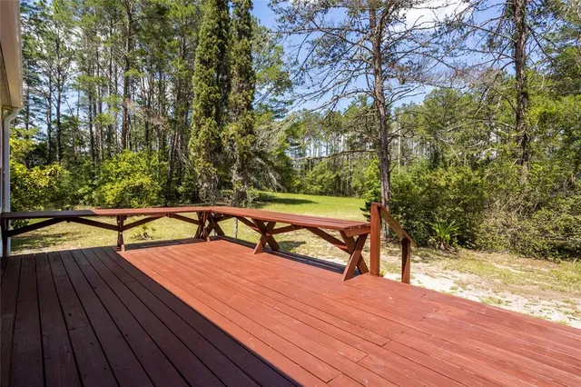 a view of a room with windows and ceiling fan