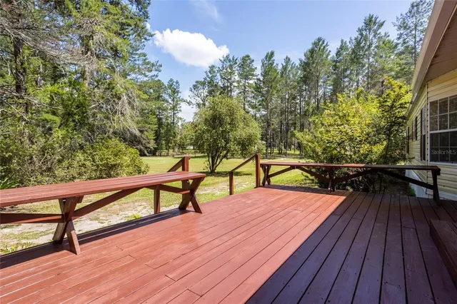 a kitchen with stainless steel appliances granite countertop a refrigerator a sink a stove a microwave and a refrigerator