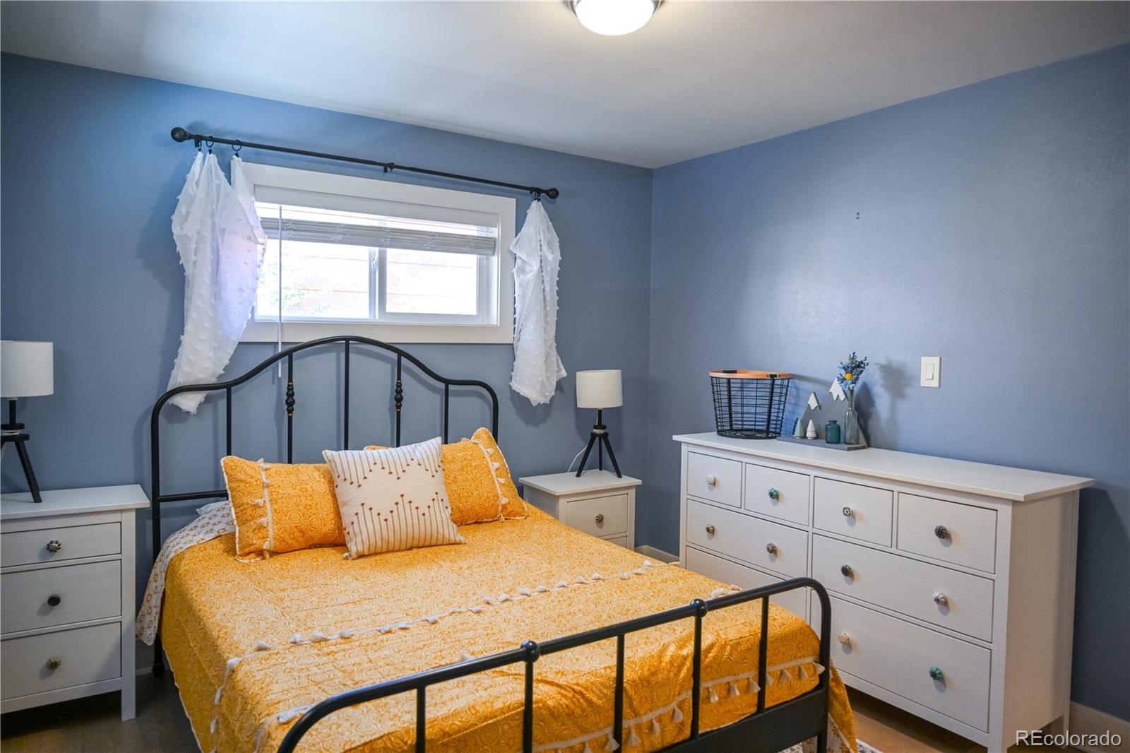 7051 Ruth Way Denver, CO 80221 - Photo 11 of 36 a bedroom with a bed and window