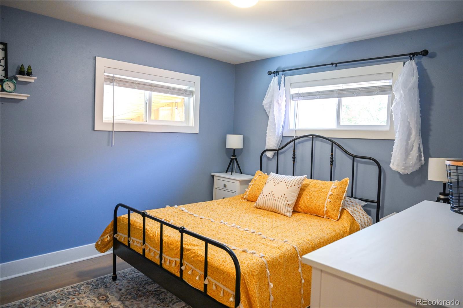 7051 Ruth Way Denver, CO 80221 - Photo 12 of 36 a bedroom with a bed and window