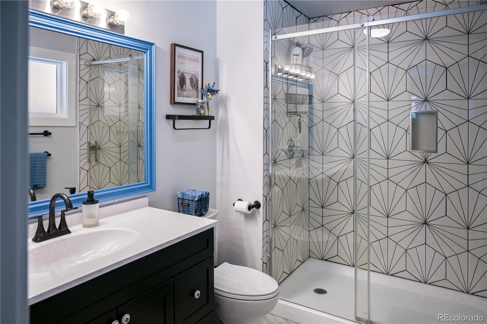 7051 Ruth Way Denver, CO 80221 - Photo 15 of 36 a bathroom with a sink and a mirror