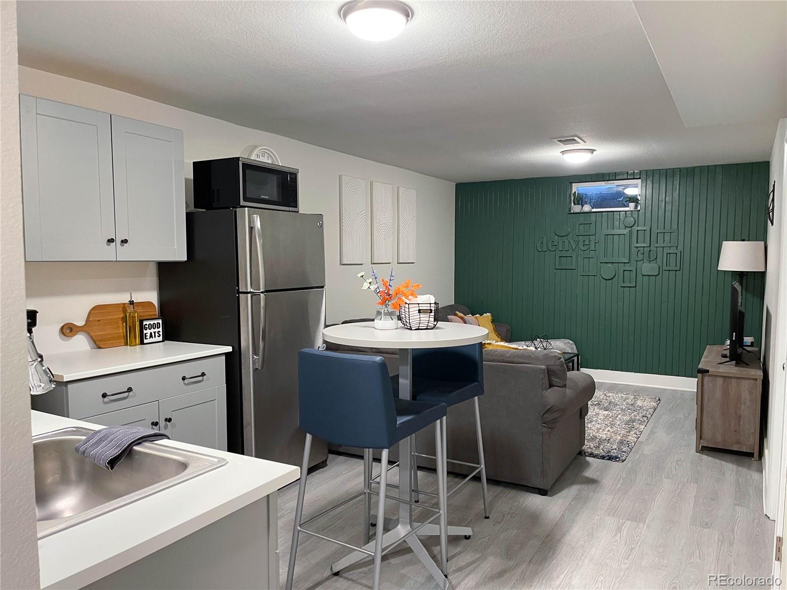7051 Ruth Way Denver, CO 80221 - Photo 20 of 36 a kitchen with a refrigerator and sink