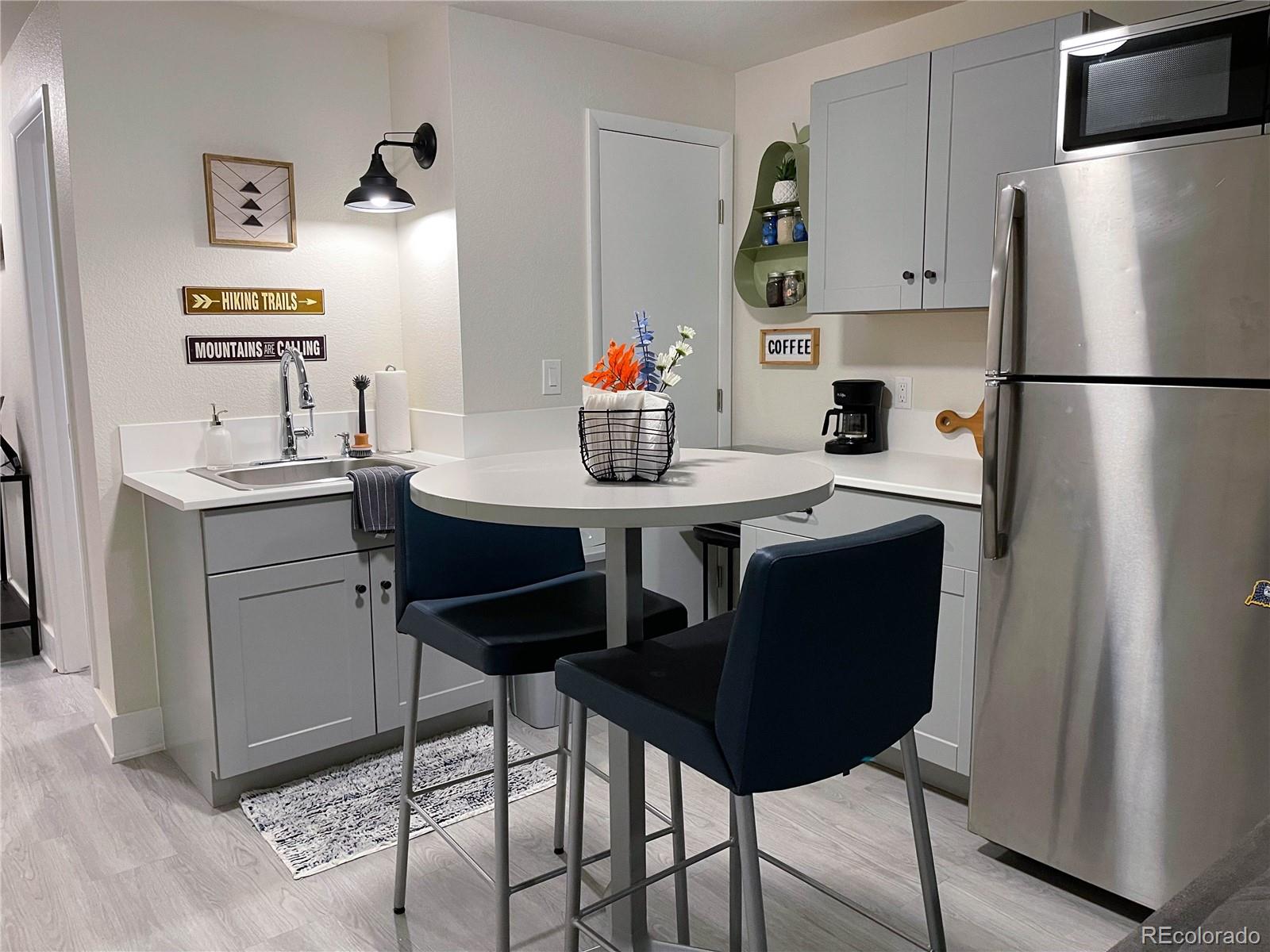 7051 Ruth Way Denver, CO 80221 - Photo 22 of 36 a kitchen with stainless steel appliances granite countertop a sink a refrigerator and a stove
