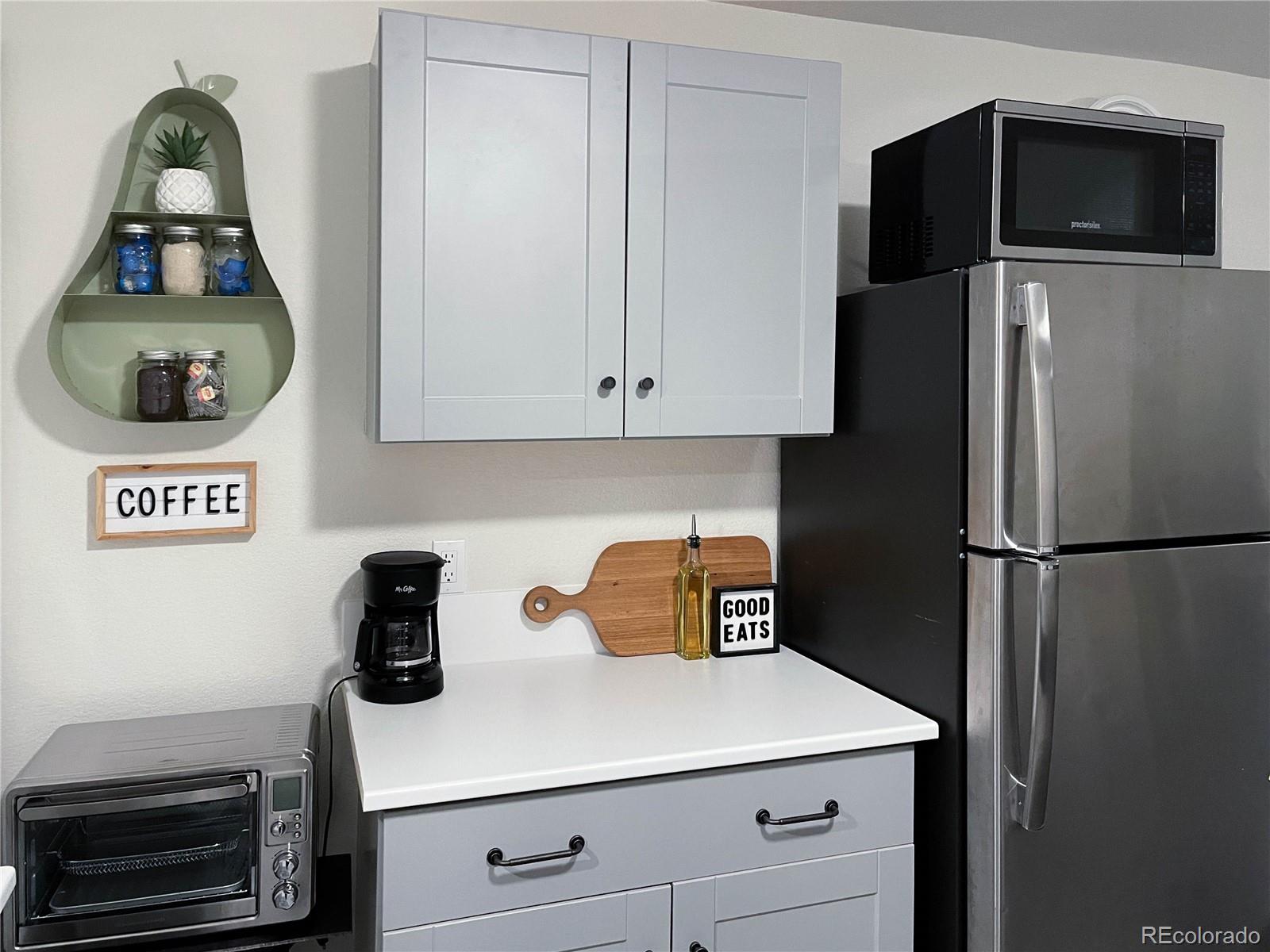 7051 Ruth Way Denver, CO 80221 - Photo 23 of 36 a kitchen with a refrigerator and cabinets