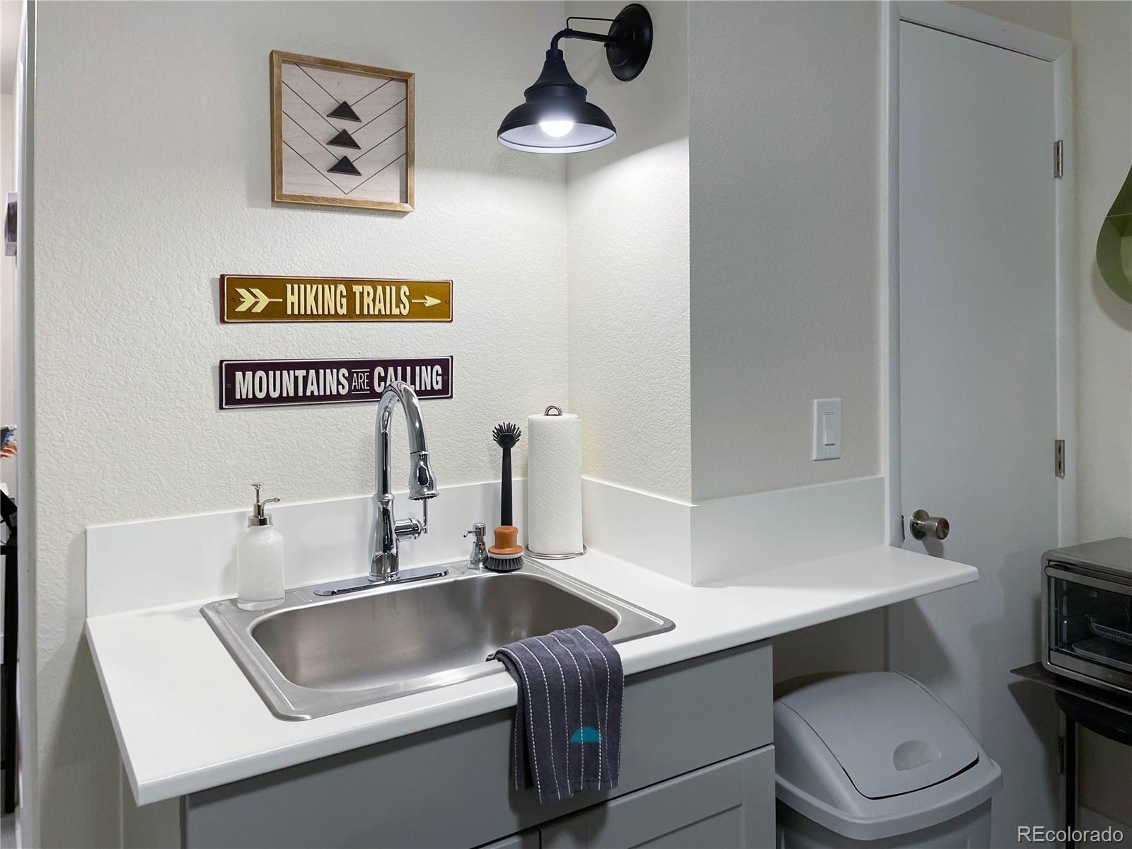 7051 Ruth Way Denver, CO 80221 - Photo 24 of 36 a kitchen with a sink and a toilet